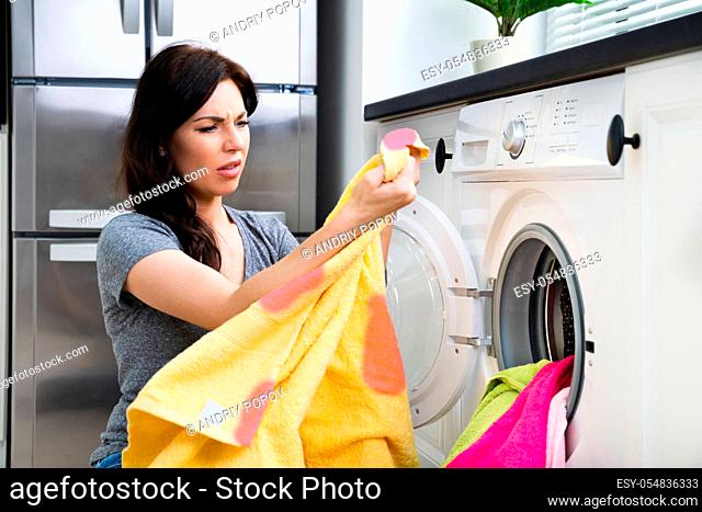 Stained Pink Clothes In Washing Machine. Laundry Cleaning