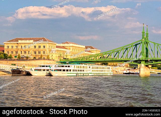 Danube river cruise ships at the Liberty Bridge and Corvinus University of Budapest, Hungary