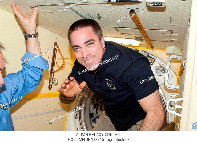 NASA astronaut Chris Cassidy, Expedition 36 flight engineer, waves good-bye to his crewmates in the Poisk Mini-Research Module 2 (MRM2) of the International...