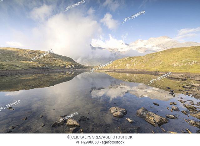 Clouds reflected in alpine lake, Bernina Pass, Poschiavo Valley, canton of Graubünden, Engadine, Switzerland