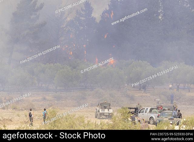 25 July 2023, Greece, -: Volunteers fight the many fires with the simplest of means, garden hoses and fire extinguishers are used