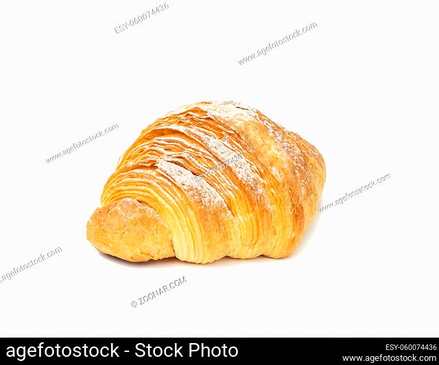 baked croissant isolated on white background and sprinkled with powdered sugar