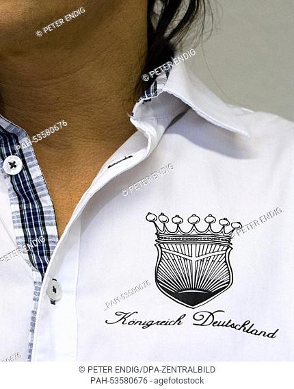 Defendent Peter F. (L) wears a shirt with the logo of his fantasy country in the courtroom in the district court in Dessau-Rosslau,  Germany, 13 November 2014