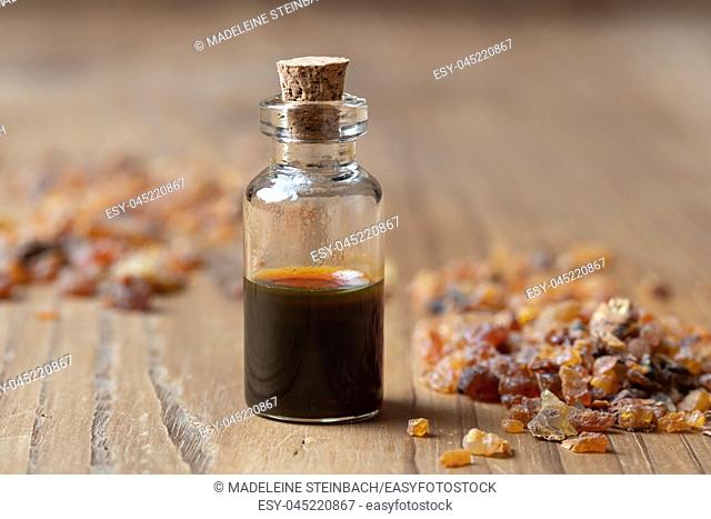 A bottle of essential oil with myrrh resin crystals
