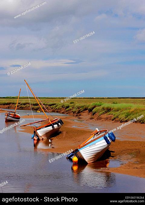 Three boats in gorgeous Blakeney, North Norfolk coast, East Anglia, UK. Ample copy space. High quality photo