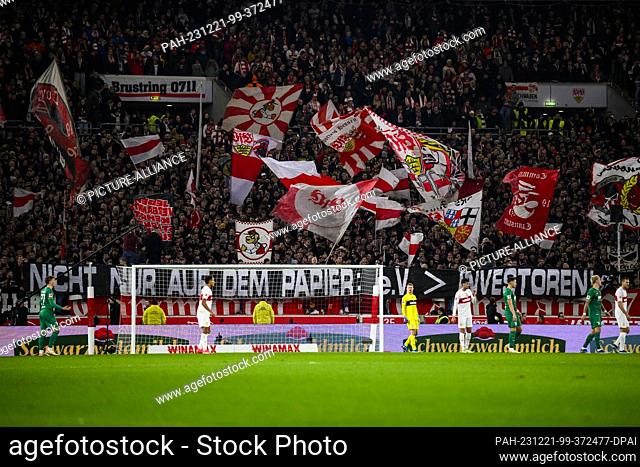 20 December 2023, Baden-Württemberg, Stuttgart: Soccer: Bundesliga, VfB Stuttgart - FC Augsburg, Matchday 16, MHPArena. VfB Stuttgart fans hold up a poster with...