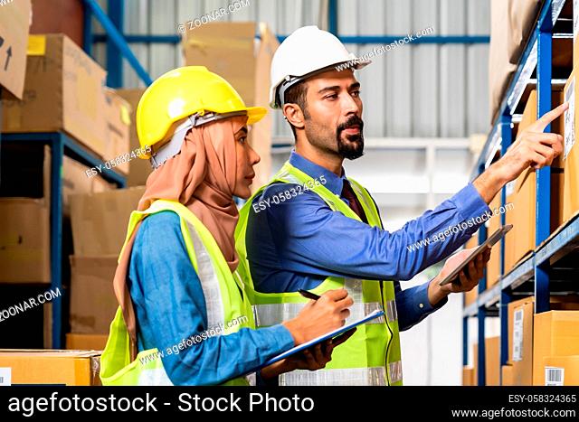 Middle east turkish white warehouse manager talk to Islam asian warehouse worker about inventory logistic route in distribution center