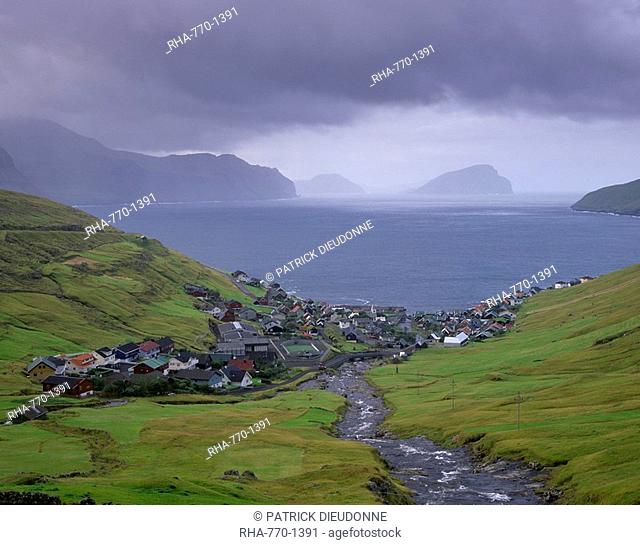Village of Kvivik and Stora river, view on Vestmannasund, Streymoy coastline, Koltur and Hestur in the distance, Streymoy, Faroe Islands Faroes, Denmark, Europe