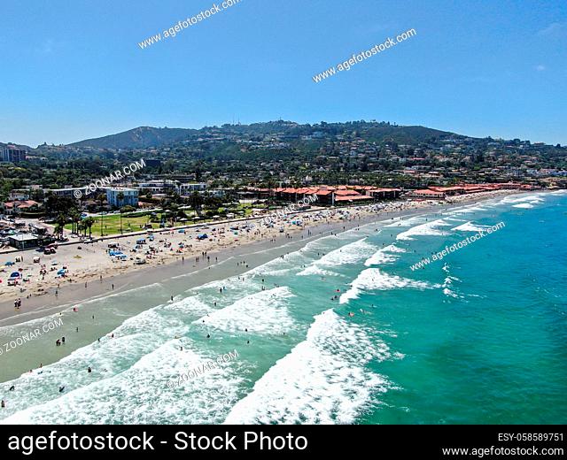 Aerial view of La Jolla bay with nice small waves and tourist enjoying the beach and summer day. La Jolla, San Diego, California, USA