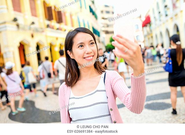 Woman use of mobile phone taking selfie