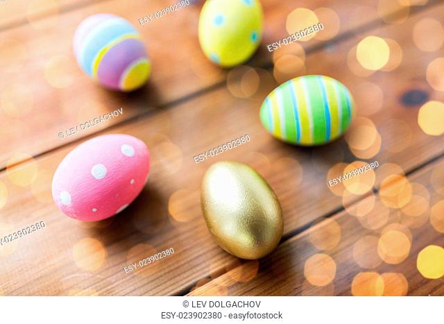 easter, holidays, tradition and object concept - close up of colored easter eggs