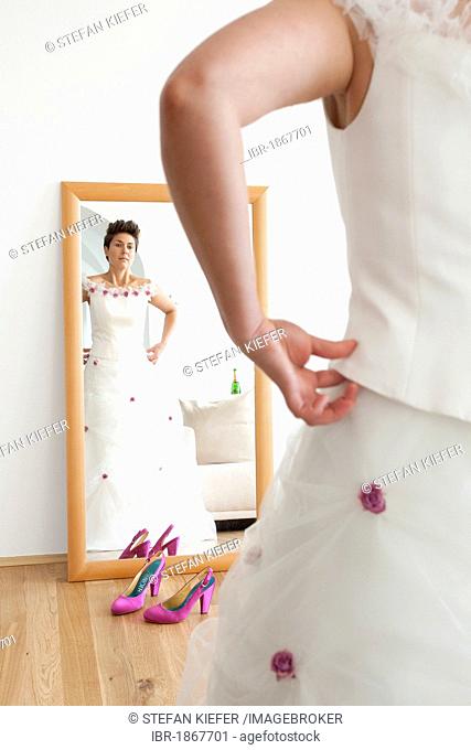 Bride looking at herself in a mirror