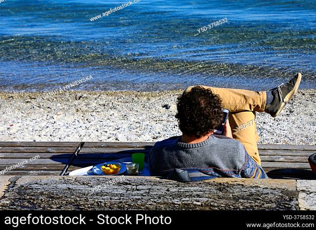 Bains des Paquis, Paquis beach on Lake Geneva in city center - most popular leisure place in Geneva, single man resting, Geneva, Switzerland, Europe
