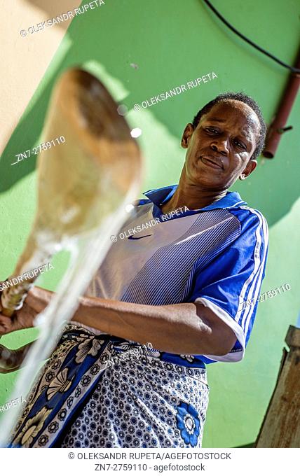 A housewife prepares liquid soap for selling in the market in Visiga Kwa Kipofu near Dar Es Salaam, Tanzania