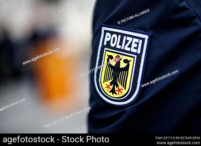09 November 2023, Bavaria, Munich: The national emblem of the Federal Police, a coat of arms with the word ""Polizei"" and an eagle
