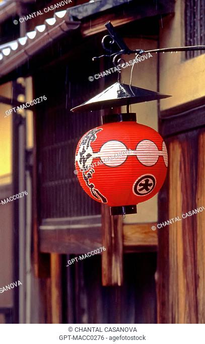 TRADITIONAL RED PAPER LANTERN CHOCHIN DECORATED WITH THE COAT OF ARMS OF THE GEISHA HOUSE OKIYA WHERE THE GEISHAS GEIKO AND APPRENTICE GEISHAS MAIKO LIVE