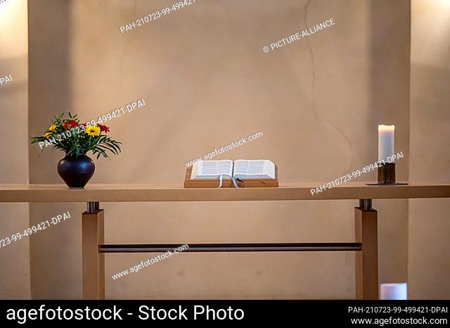 23 July 2021, North Rhine-Westphalia, Wuppertal: A Bible lies on a table while Pastor Johannes Nattland speaks during a service in memory of the victims of the...