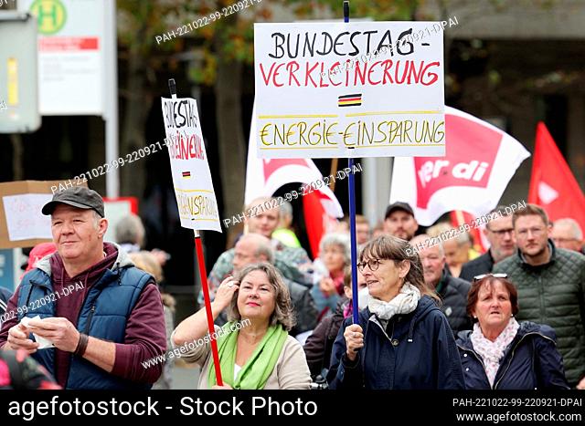 22 October 2022, North Rhine-Westphalia, Duesseldorf: Two participants carry placards with the inscription 'Bundestag Verkleinern- Einergi· ·insparung'