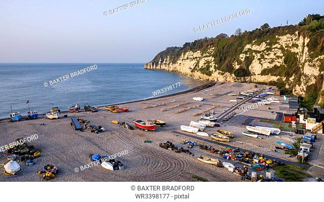 Fishing boats and deckchairs on the popular pebbled beach at Beer near Seaton, Devon, England, United Kingdom, Europe