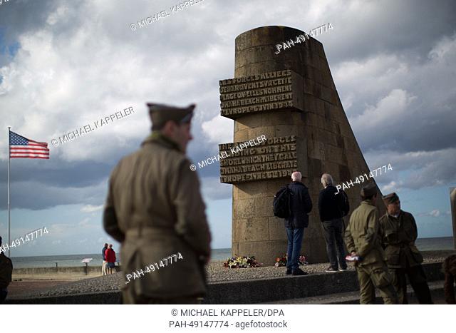 Military enthusiasts arrive before the D-Day anniversary celebrations to indulge their hobby and stand at the D-Day monument at Omaha Beach in Vierville Sur Mer