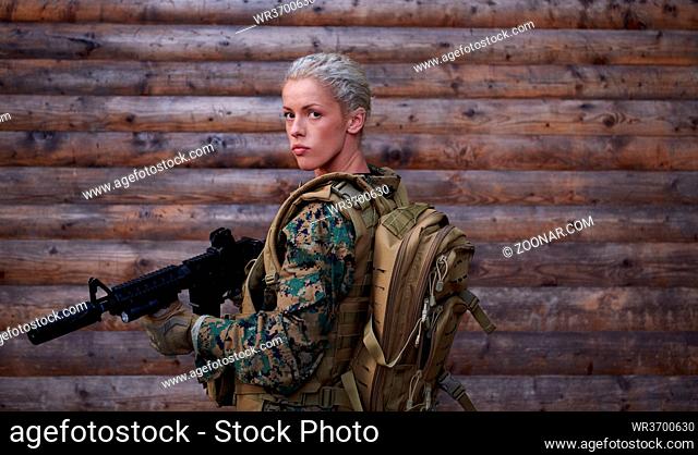 woman soldier ready for battle wearing protective military gear and weapon