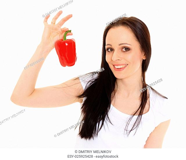 Portrait of a beautiful young woman with a fresh red pepper on a white background