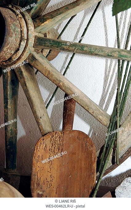 Wagon wheel and wooden shovel, close-up