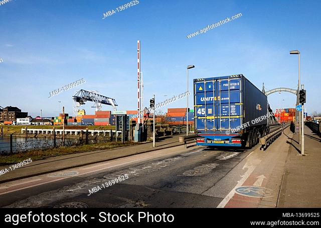 Krefeld, North Rhine-Westphalia, Germany - The Rheinhafen Krefeld is the fourth largest port in North Rhine-Westphalia, container trucks drive over the historic...