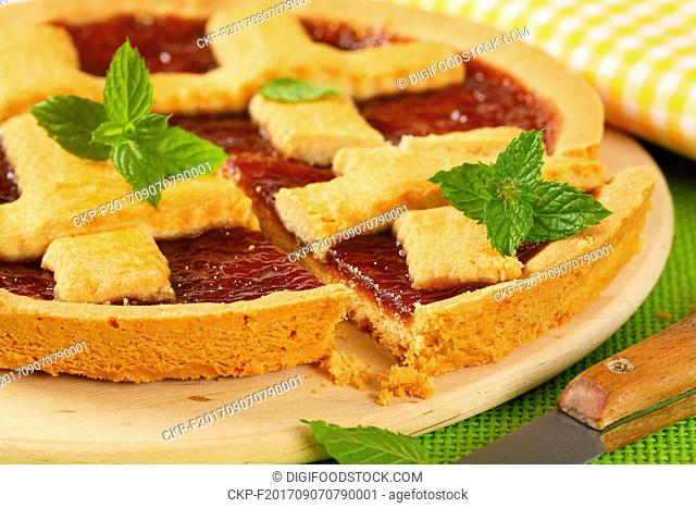 close up strawberry jam tart with lattice on top