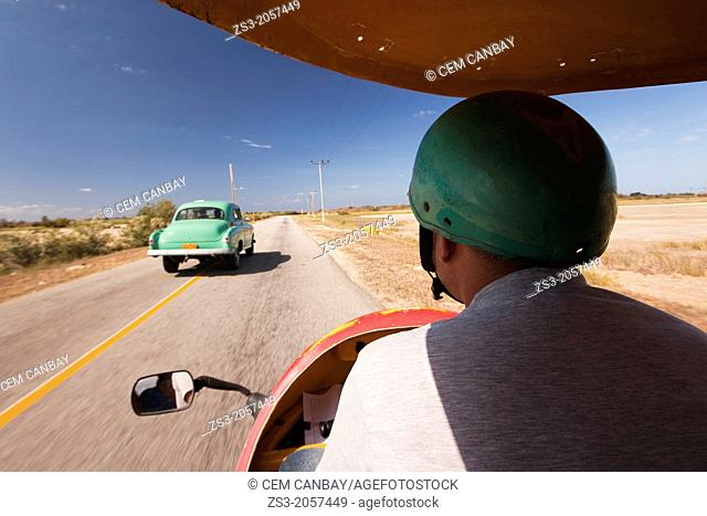 Coco Taxi driving at Peninsula Ancon; Trinidad, Sancti Sp’ritu Province, Cuba, Central America