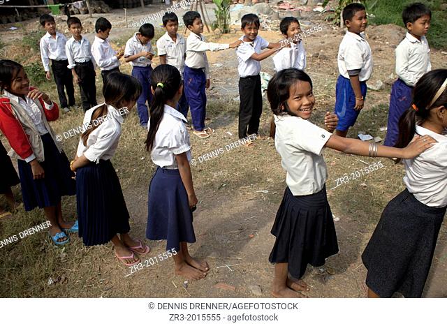 School children line up after recess in a village school near Battambang, Cambodia