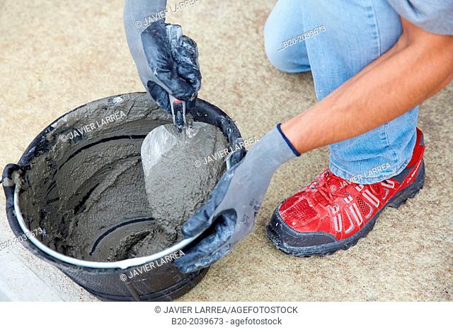 Bricklayer making cement mortar. Construction of residential building. Donostia. San Sebastian. Gipuzkoa. Basque Country. Spain