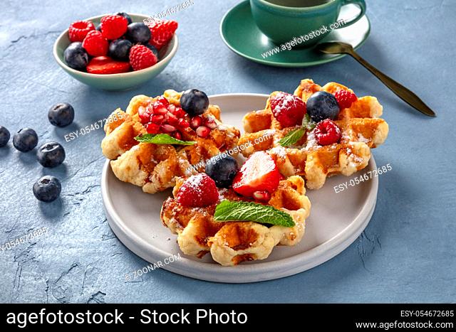 Belgian waffles with fresh fruit and mint leaves, a delicious breakfast