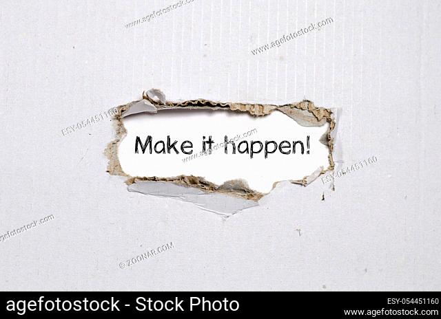 The word make it happen appearing behind torn paper