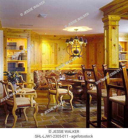 FAMILY ROOMS - Multipurpose basement area. Gaming area off bar, round table with wrap around booth. African influence in fabric pattern
