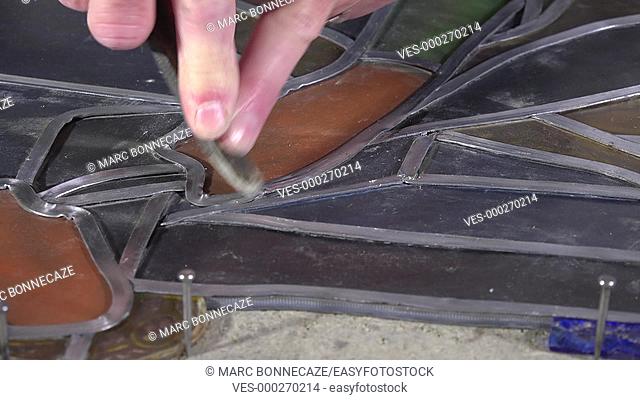 introduction of lead rods to crimp the glass pieces