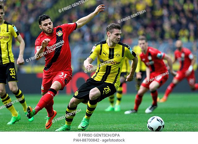 Dortmund's Lukasz Piszczek (r) in action against Kevin Volland (l) from Leverkusen during the German Bundeliga soccer match between Borussia Dortmund and Bayer...