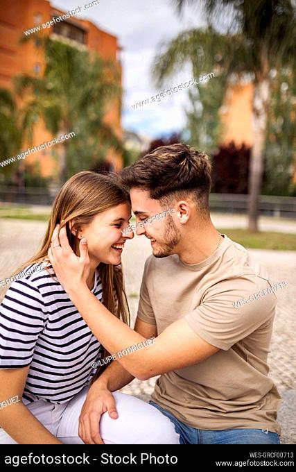 Smiling girlfriend with boyfriend in park