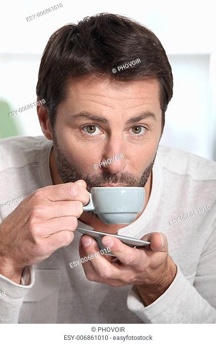 Man drinking espresso