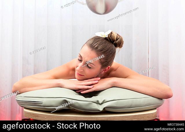 Beautiful young woman sleeping on spa bed