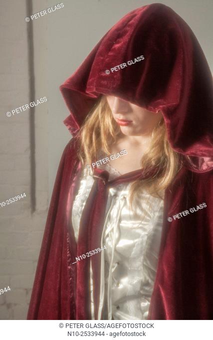 Blonde teenage girl wearing a robe with a hood