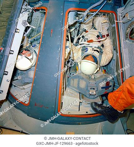 The Gemini-10 prime crew undergoes zero-gravity egress training aboard a KC-135 Air Force plane. Astronaut John W. Young, command pilot, is on left