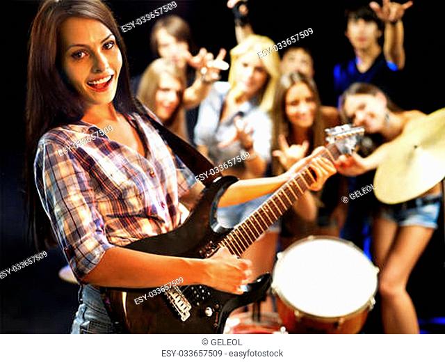 Musical group playing in night club. Male and female