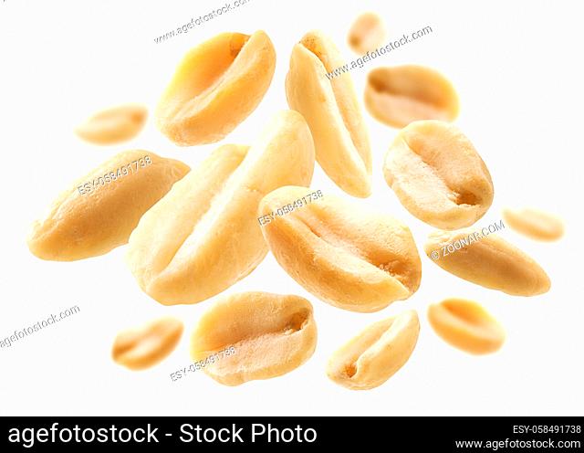Peeled peanuts levitate on a white background