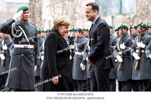 20 March 2018, Germany, Berlin: German Chancellor Angela Merkel (l, CDU) receives Irish Prime Minister Leo Varadkar with military honours at the German...