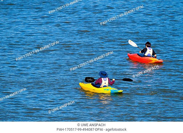 Two canoeists make their way across the Neckar river in Heidelberg, Germany, 17 May 2017. Photo: Uwe Anspach/dpa
