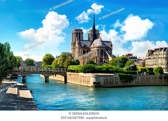 Notre Dame de Paris on river Seine and cloudy sky, France