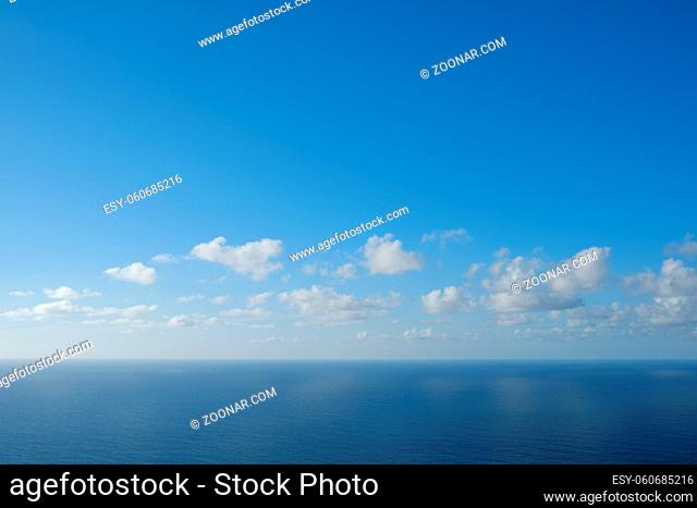 blue sky above ocean horizon with clouds