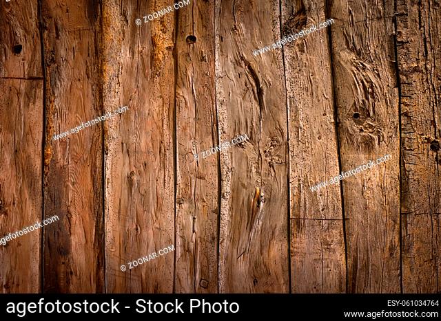 Old weathered brown wood planks background with nice studio lighting and elegant vignetting to draw the attention