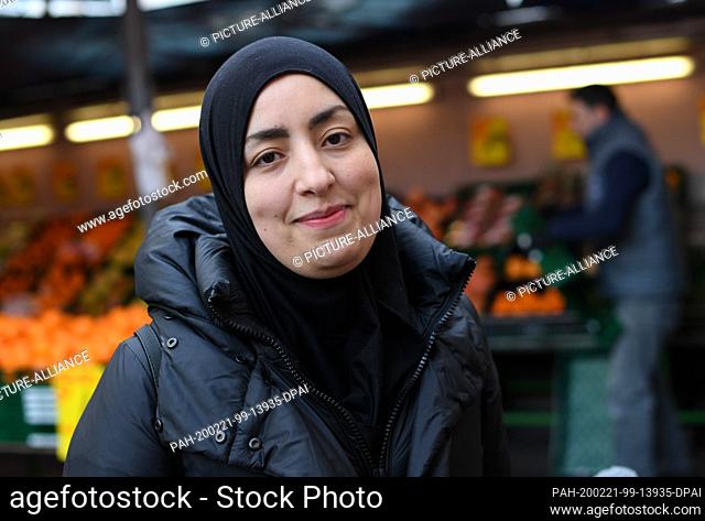 21 February 2020, Hessen, Frankfurt/Main: Ghizlane Abouassam, a Moroccan childminder, is standing in front of a food market in Münchner Straße